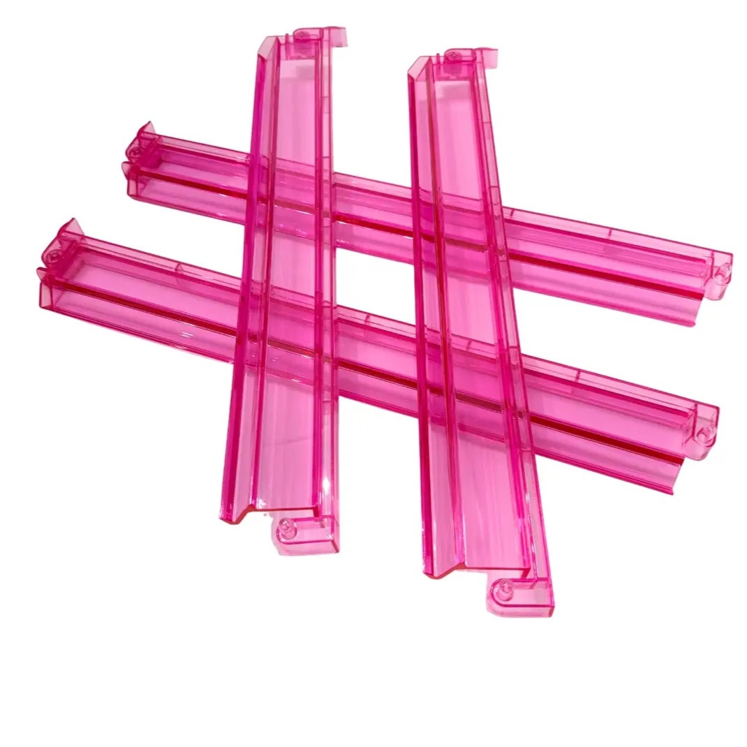 Four transparent hot pink Mahjong racks with integrated pushers