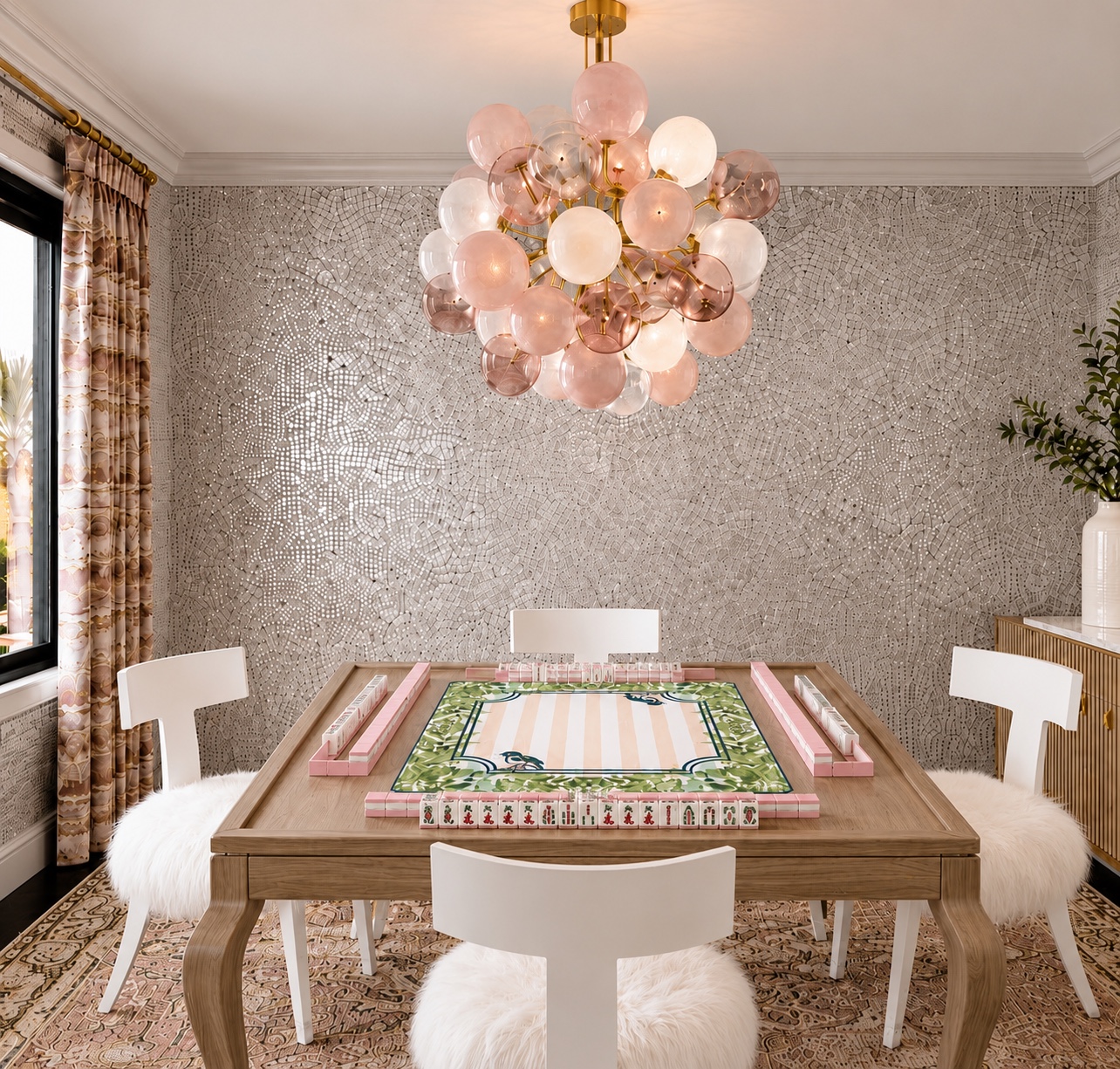 A bright custom Mahjong room with a game table, four chairs, and a pink glass chandelier